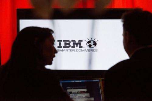 People speaks in front of IBM screen on November 14, 2012 in Paris