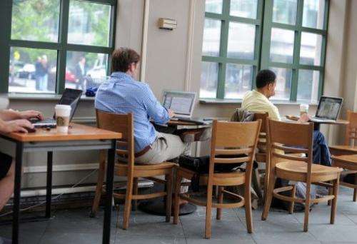 People use their laptop computers at a starbucks in Washington, DC, on May 9, 2012