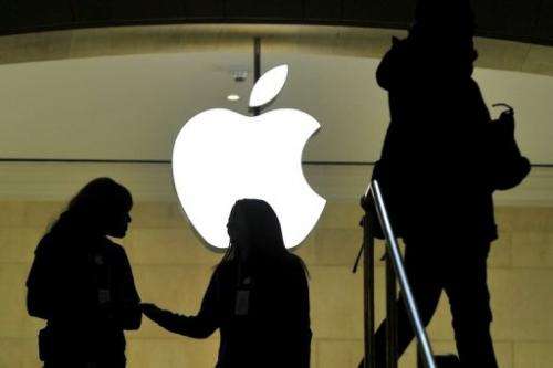 People walk past the Apple logo at the Apple Store at Grand Central Terminal in New York on January 25, 2013