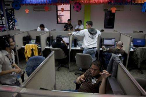 People work at SITEL, an outsourcing call center provider, in Managua, Nicaragua on July 03, 2012