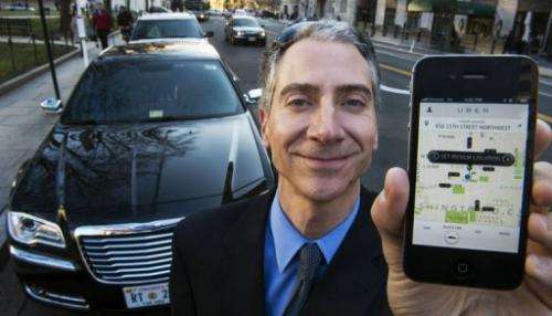 Peter Faris, CEO of Szabo Faris LLC Transportation Solutions, holds a smart phone on February 14, 2013 in Washington