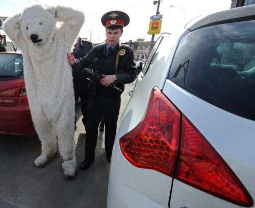 Police officers detain Greenpeace activists wearing polar bear costumes in Moscow, on April 25, 2013