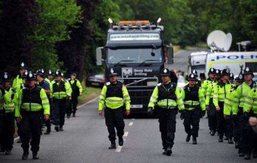 Police personnel escort a lorry to a drill site operated by Cuadrilla Resources in Balcombe,  England, on July 31, 2013