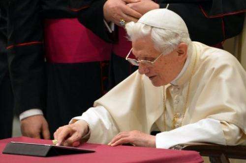 Pope Benedict XVI sends his first twitter message on December 12, 2012 at the Paul VI hall at the Vatican