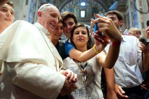 Pope Francis poses with young people in the Church of Saint Augustine in Rome on August 28, 2013