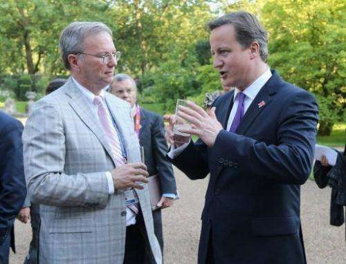 Prime Minister David Cameron (R) speaks with Eric Schmidt of Google during a reception on July 26, 2012, in London