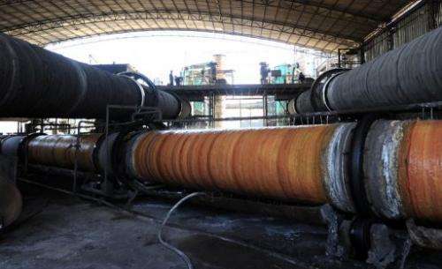 Rare earths undergoing processing in large steel pipes are cooled at a factory  in Inner Mongolia on April 21, 2011