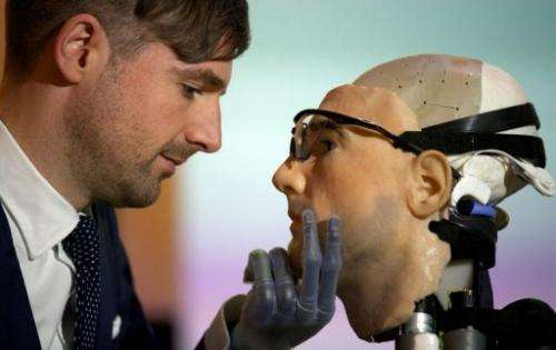 Researcher Bertolt Meyer poses with the model for "Rex", the world's first "bionic man" in London on February 5, 2013