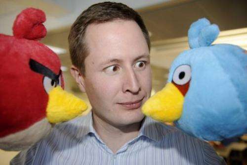 Rovio CEO Mikael Hed poses with  two &quot;Angry Bird&quot; characters at the company premises in Espoo on January 21, 2011
