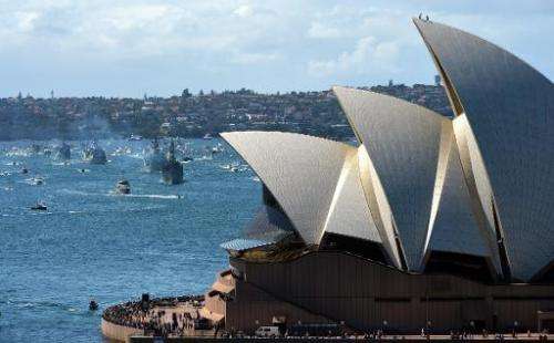 Royal Australian Navy warship HMAS Sydney leads the ceremonial fleet in front of Sydney Opera House on October 4, 2013