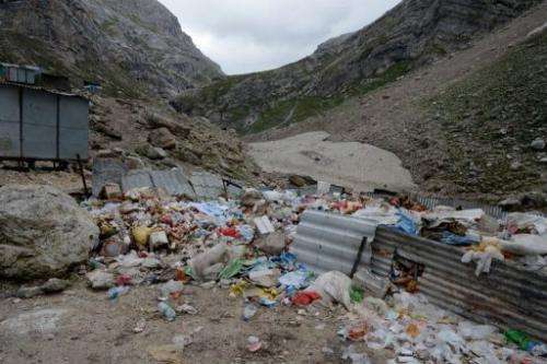 Rubbish lies in a partially fenced off area along the track to the Amarnath cave shrine on August 18, 2013