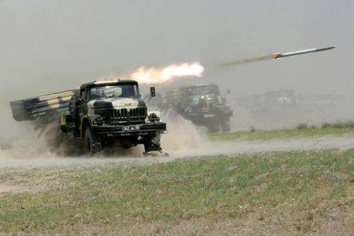 Russian-built rocket systems fire during military exercises in Tajikistan on June 10, 2012