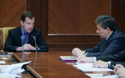 Russian Prime Minister Dmitry Medvedev (L) &amp; Roscosmos chief Vladimir Popovkin attend a meeting, Moscow, August 14, 2012
