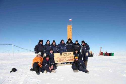 Russian researchers pose for a picture after reaching  the subglacial Lake Vostok in Antarctica on February  5, 2012