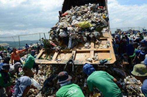Scavengers collect recyclable materials at a temporary landfill in Payatas village, Quezon City, March 5, 2013