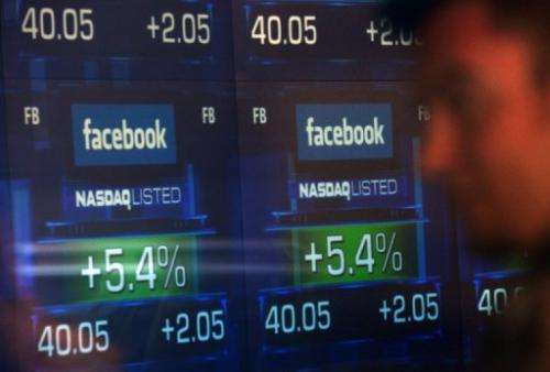 Screens display the start of trading in Facebook shares at the NASDAQ stock exchange, May 18, 2012