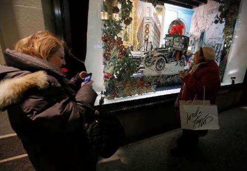 Shoppers admire a holiday window display of the Lord &amp; Taylor Flagship store, in New York, on November 13, 2013