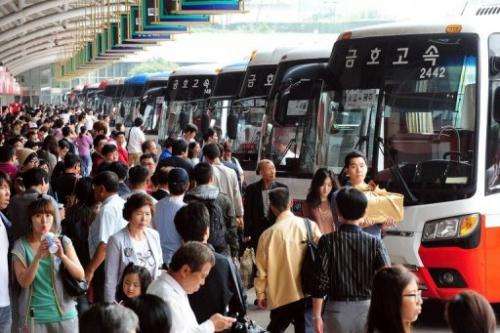 South Korean passengers queue at a bus termial in Seoul on September 10, 2011
