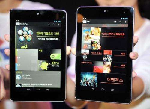 South Korean women show Google's new tablet PC, Nexus 7,  in Seoul on September 27, 2012