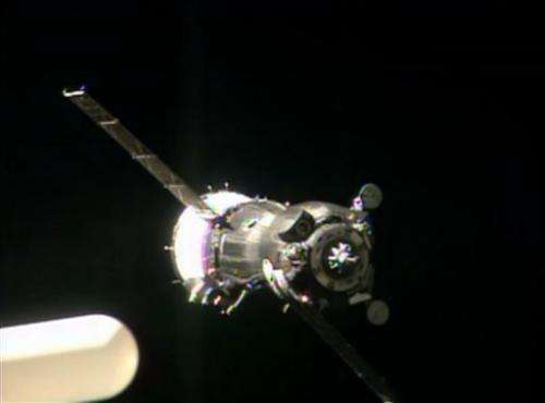 Soyuz capsule docks with space station