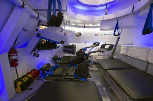 Spacesuited astronauts climb aboard Boeing CST-100 commercial crew capsule for key tests