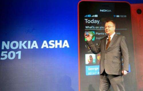 Stephen Elop holds a Nokia Asha 501 mobile phone as he addresses an unveiling ceremony in New Delhi on May 9, 2013