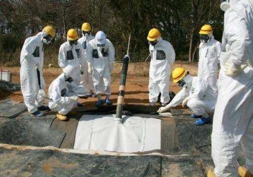 TEPCO officials inspect radioactive reservoirs at the Fukushima Dai-Ichi facility in Okuma, on April 13, 2013.
