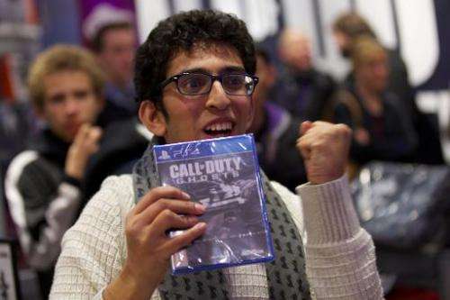 The first customer picks up Call of Duty: Ghosts in a shopping centre in east London at its midnight launch on November 4, 2013