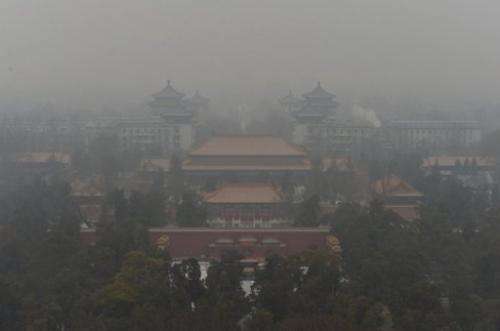 The Guotai Chambers building from the historic Jingshan Park as smog continues to shroud Beijing on January 31, 2013