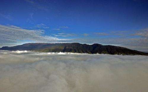 The summit of Mount Hagen towers above the clouds covering the Western Highlands of Papua New Guinea, on July 4, 2007