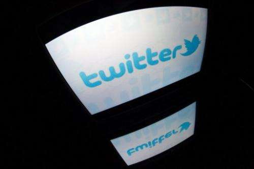 The "Twitter" logo is seen on a tablet screen on December 4, 2012 in Paris.