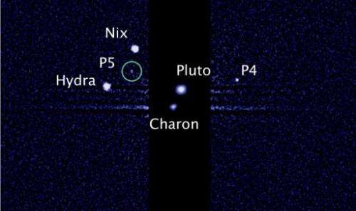 This image, taken by the NASA/ESA Hubble Space Telescope, shows five moons orbiting Pluto, the distant, icy dwarf planet
