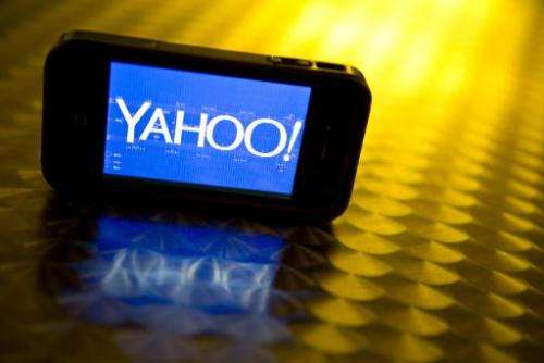 This September 12, 2013 photo illustration shows the newly designed Yahoo logo seen on a smartphone