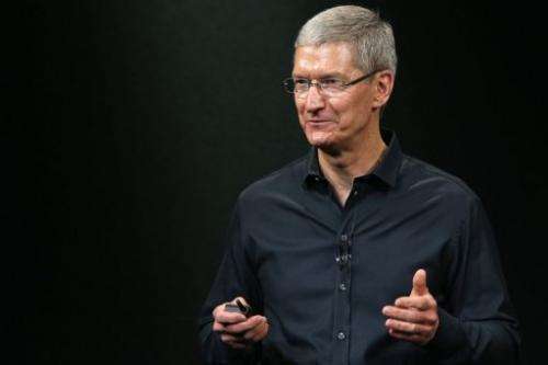 Tim Cook speaks on stage during an Apple product announcement in Cupertino, California on September 10, 2013