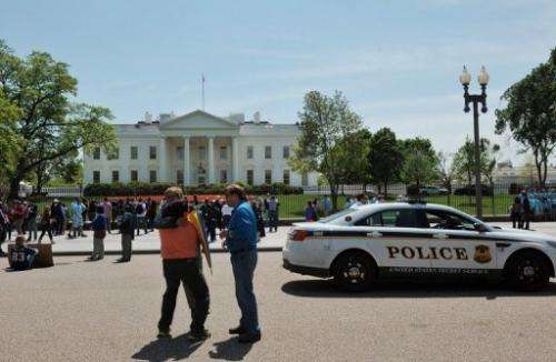 Tourists are pictured outside the White House in Washington DC on April 24, 2013