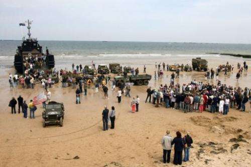 Tourists boarding a landing craft on the beach of Arromanches-les-Bains, northern France on June 6, 2009