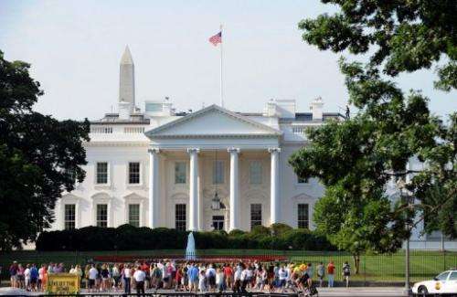 Tourists gather in front of the White House in Washington, DC, on June 15, 2009