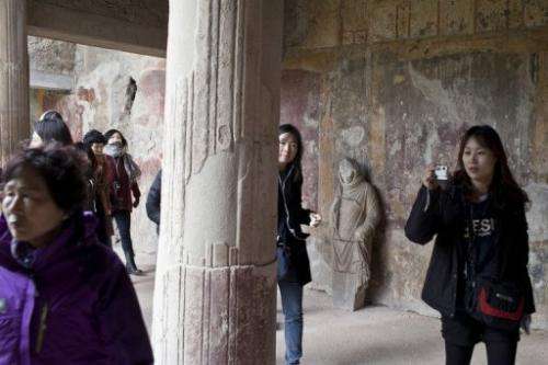Tourists visit the restored Thermae Stabianae baths in Pompeii, Italy, on March 8, 2012