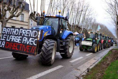 Tractors block a street during a demonstration against governmental regulations on nitrate in France, January 16, 2013