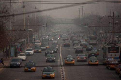 Traffic makes its way through Beijing on January 12, 2013