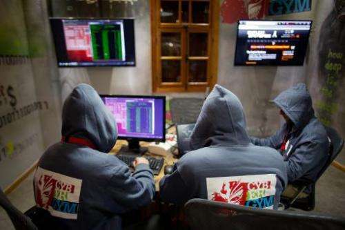 Trainees work at the &quot;Cyber Gym&quot; centre, where IT and infrastructure company employees train to defend against cyber a