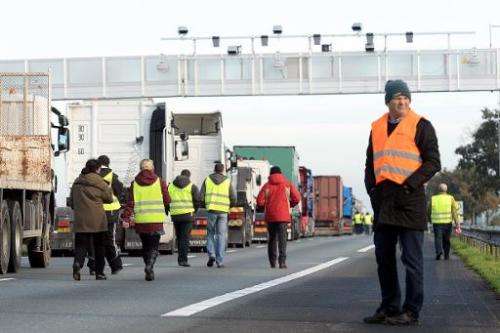 Truck drivers block a part of the A10 highway near Marcheprime, western France, to protest against an environmental tax on Novem