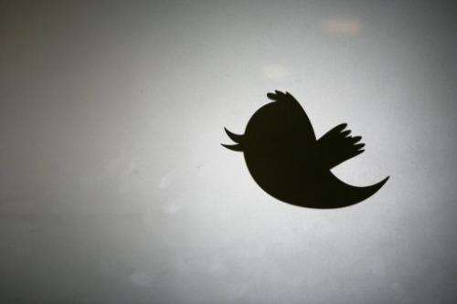 Twitter logo is displayed at the entrance of Twitter headquarters in San Francisco on March 11, 2011 in California