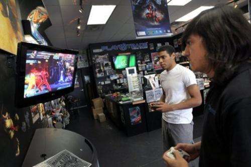 Two men plays against each other in a violent game at a store in Miami, Florida, on June 27, 2011