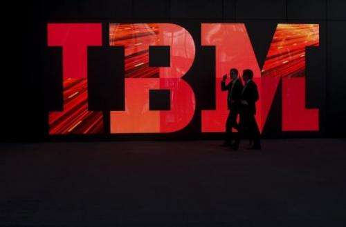 Two men walk past an IBM logo on February 28, 2011 in Hanover, central Germany