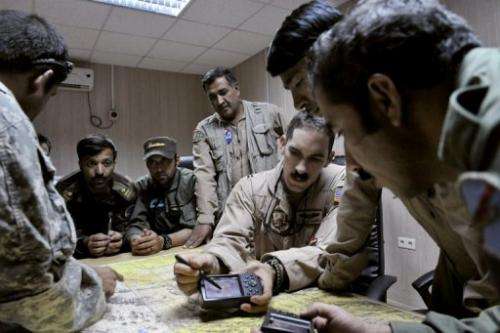 US Air Force Captain Tyler Rennell (3rd right) shows Afghan pilots how to use a GPS in Kandahar on October 11, 2009