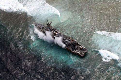 US Navy minesweeper, the USS Guardian, pictured as it remains trapped on the Tubbataha Reef, on January 19, 2013