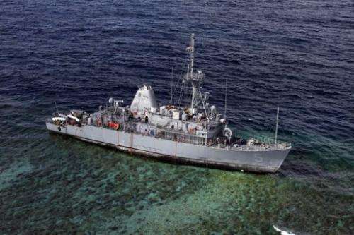 USS Guardian warship sits aground on the Tubbataha Reef in the Sulu Sea, on January 22, 2013