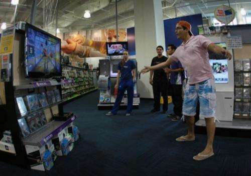 Vicente Galarza plays a Microsoft Kinect game at the Best Buy store on November 4, 2010 in Miami Beach, Florida