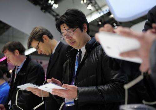 Visitors check a Samsung Galaxy note tablet at the 2013 Mobile World Congress in Barcelona, on February 26, 2013